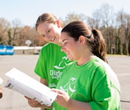 Smiling Girls on the Run Coach holding lesson plan 